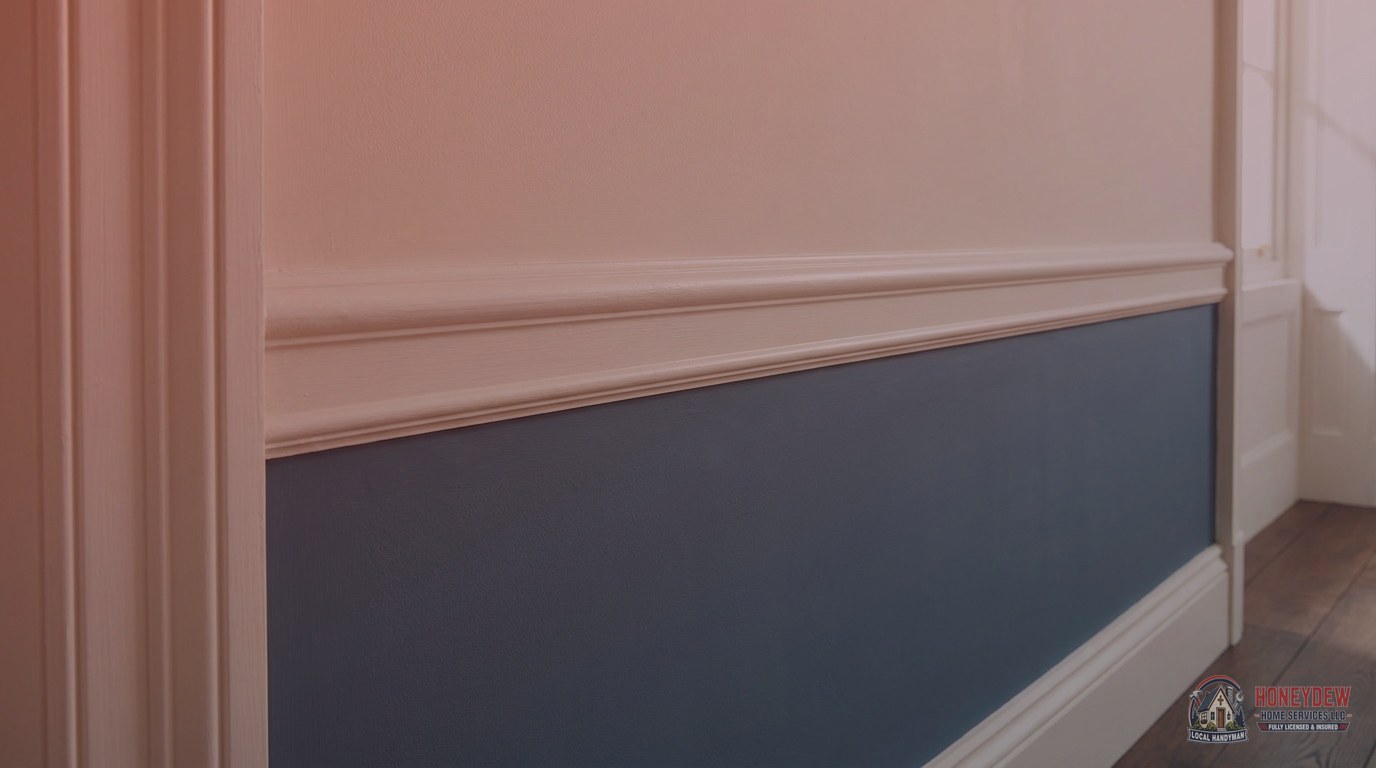Chair rail molding dividing a two-tone painted hallway wall in a traditional residential home interior.